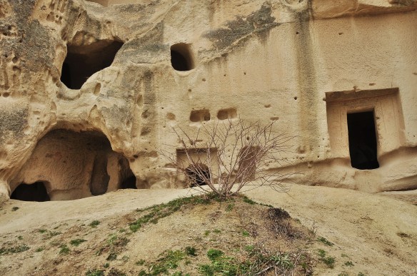 This is pretty typical, to see many doors and windows all over one rocks. It's fun to imagine how many cave houses must have been used in its prime!