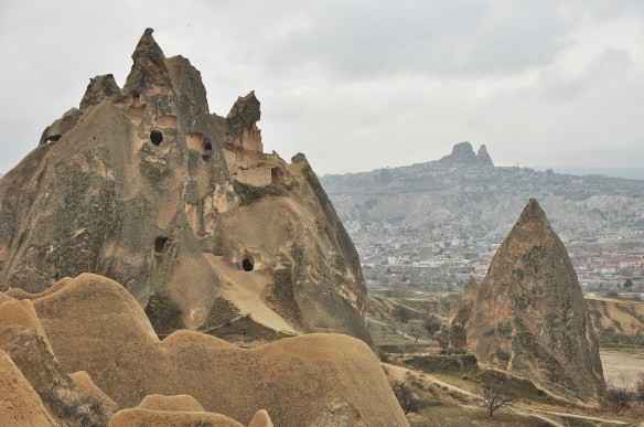 A few more windows, and in the distance, another town of caves surrounding a tall rock.