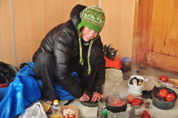 Cooking in an unfinished hut we found at the side of the road, very thankful to have a dry place to cook!