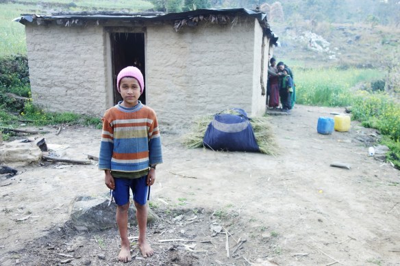 Behind this boy is his house, the house I stayed with during my four days in the village.